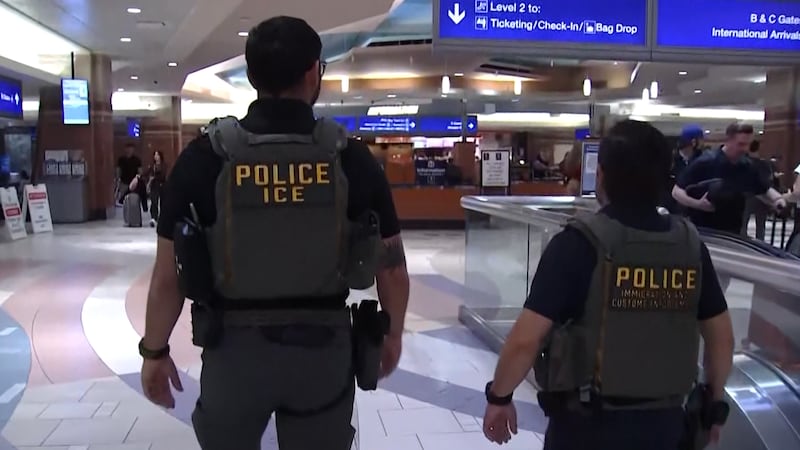 ICE agents walk through Sky Harbor Airport after being sent to help with a TSA shortage in...