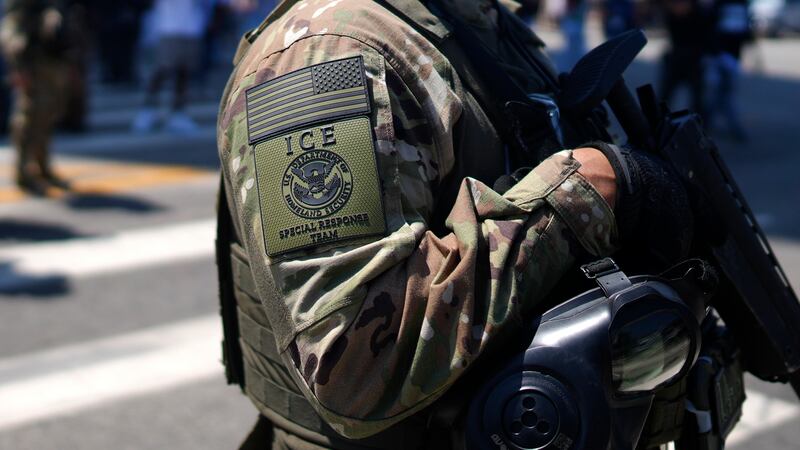 An ICE Special Response Team member stands guard outside the Metropolitan Detention Center,...